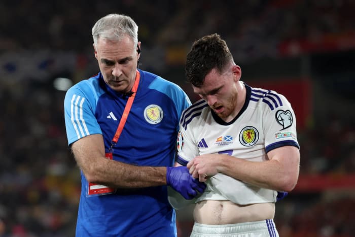 Andrew Robertson pictured (right) leaving the field after sustaining a shoulder injury during Scotland's Euro 2024 qualifier against Spain in October 2023